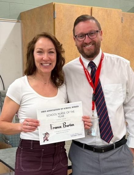 two people one holding a certificte