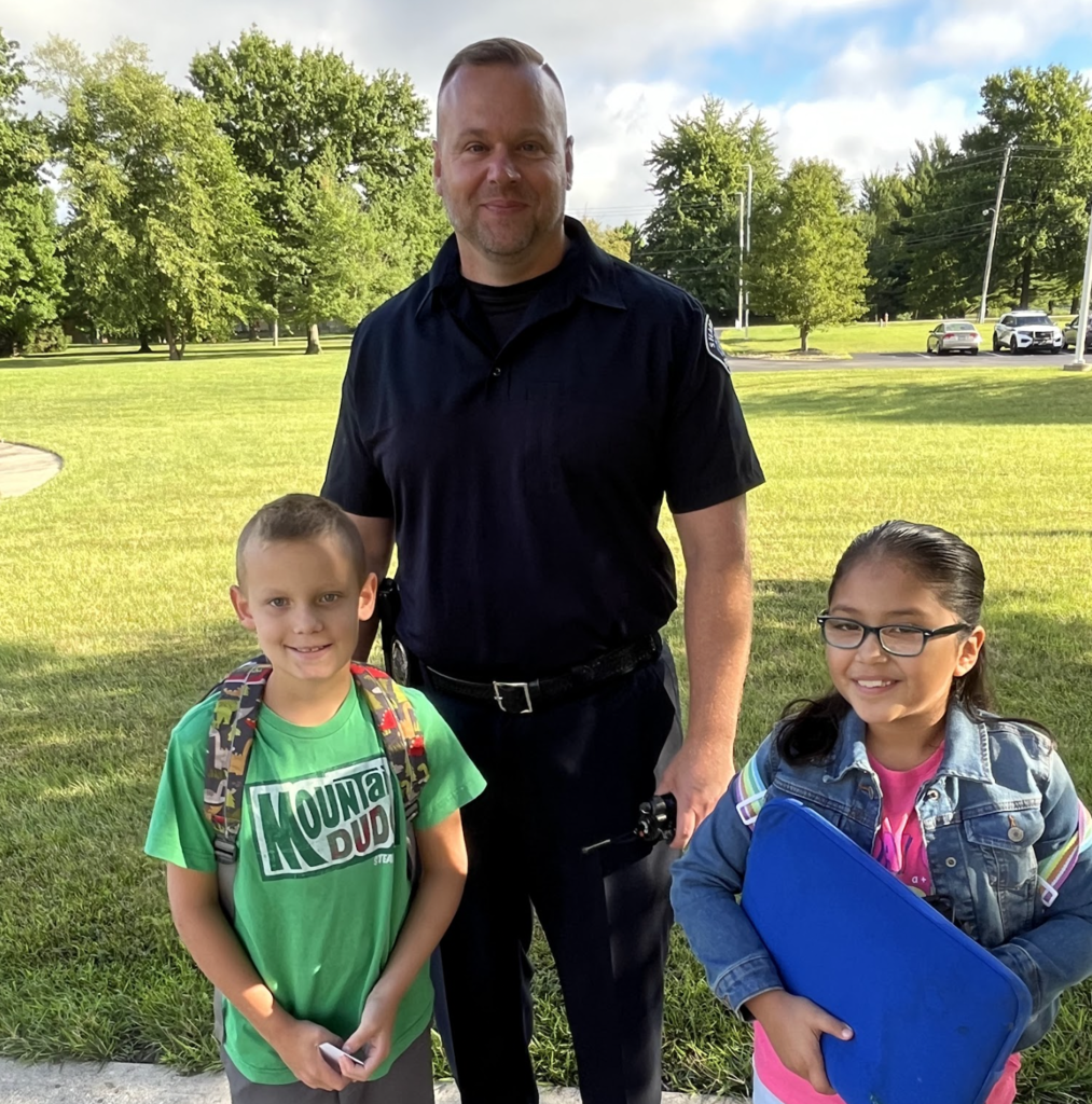 Officer Hayes with two Stewart Elementary students