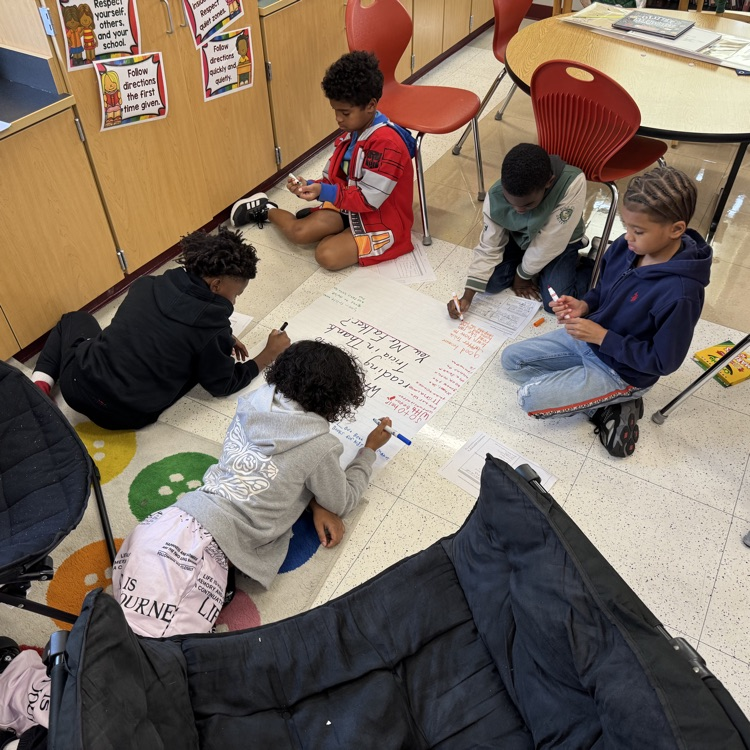 4th graders working together on a new Wit & Wisdom skill called a Chalk Talk