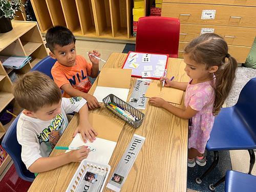 Pre K friends writing with friends