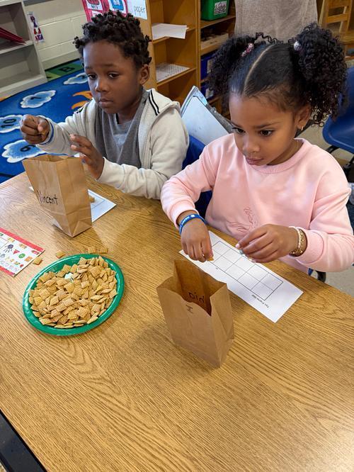 students making a 100 day snack mix