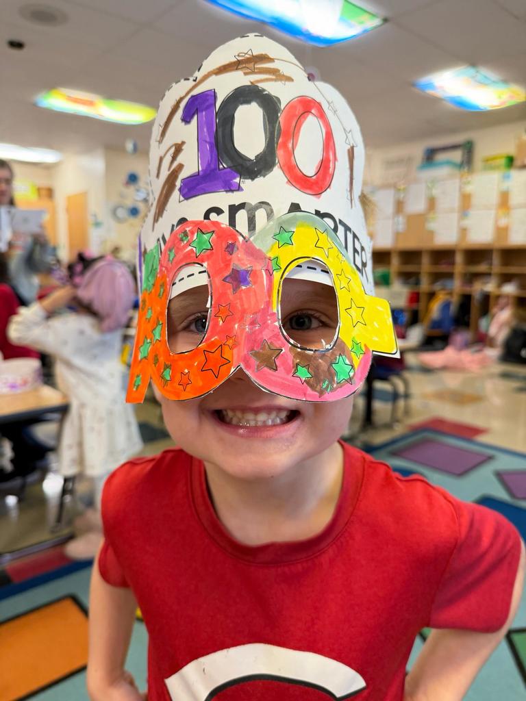 smiling student with a crown with 100 day #EV