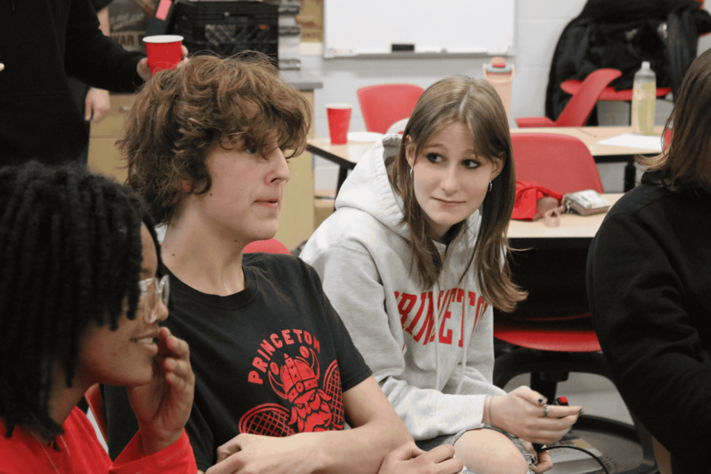 Students looks for the answer from another student