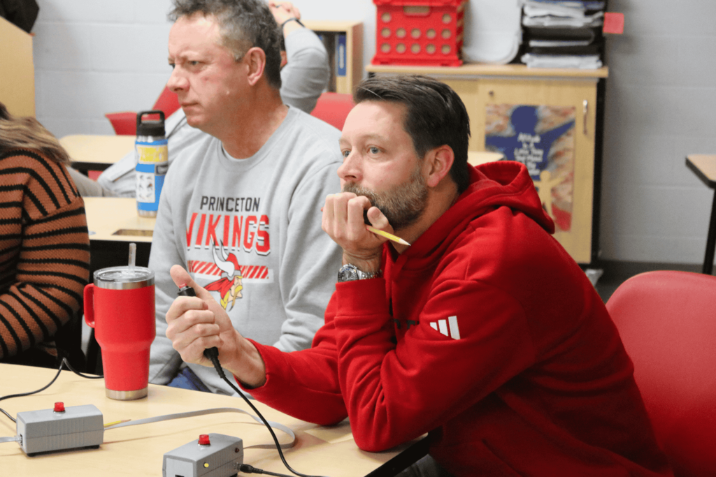 Teacher deep in thought during the quiz match against students