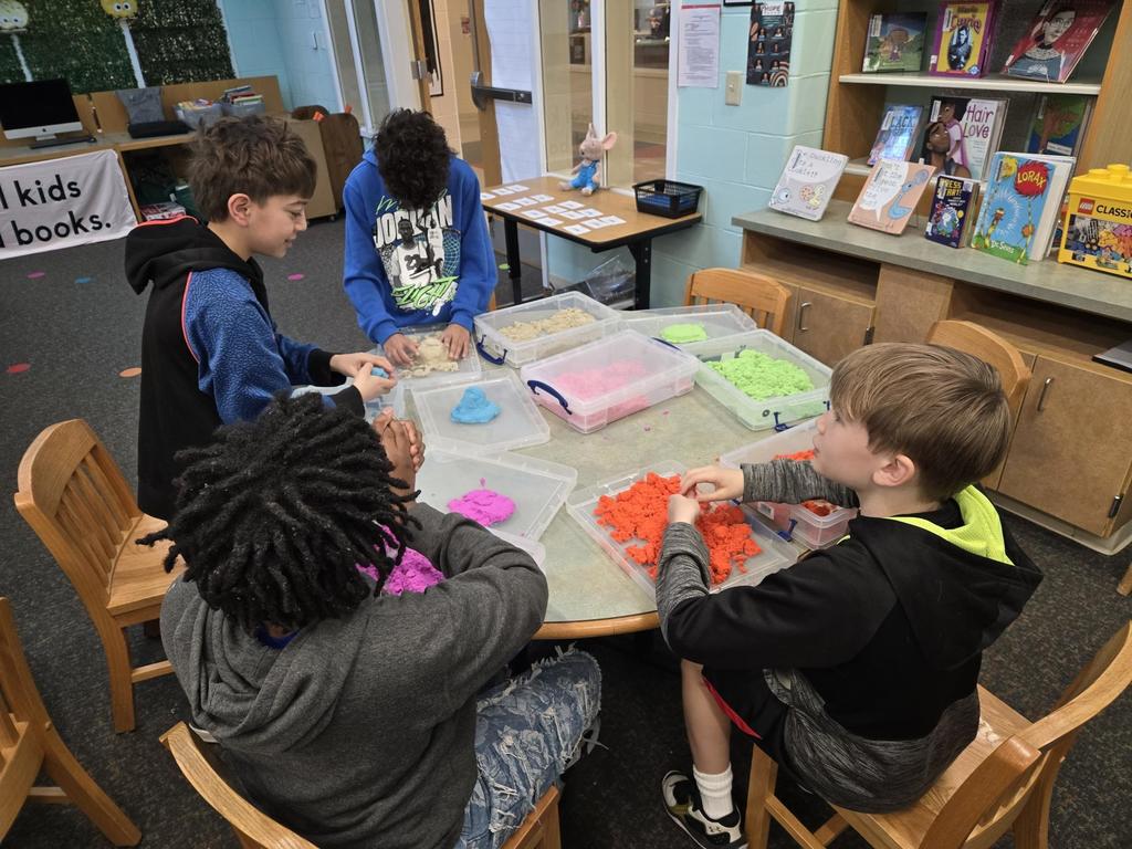#EV student in the library exploring kinetic sand at tables