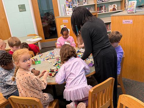 #EV students exploring with plastic brick pieces in library