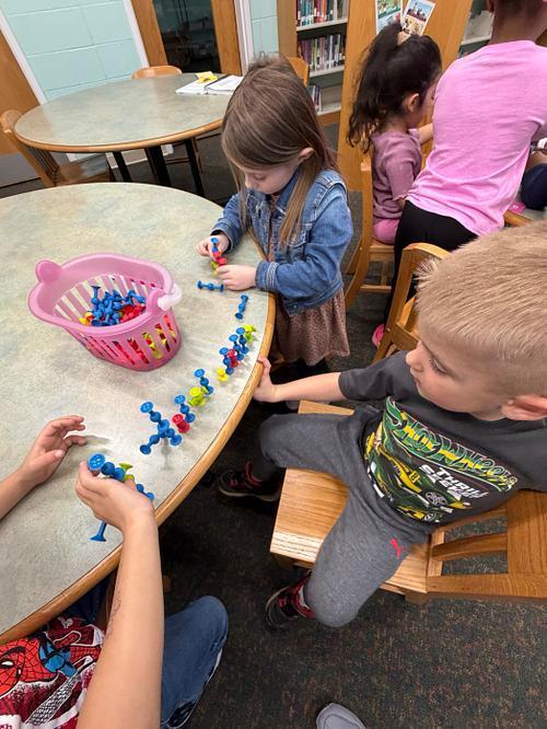 #EV student exploring with figits in library