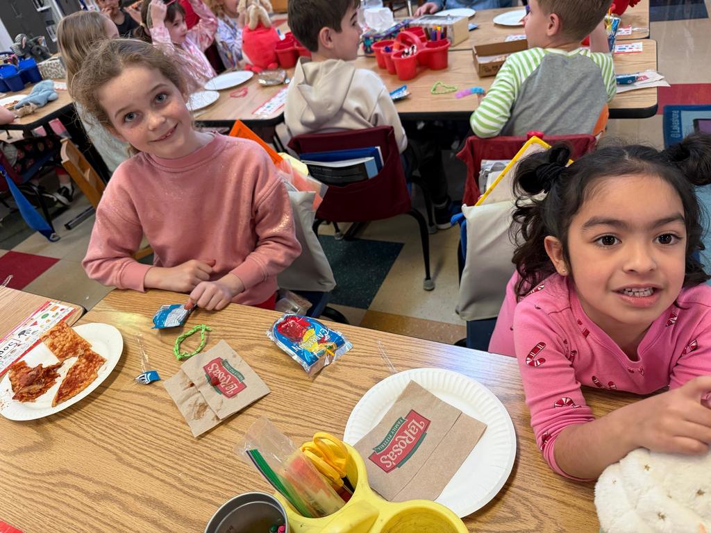students eating pizza in a classroom