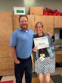 people holding flowers and awards 