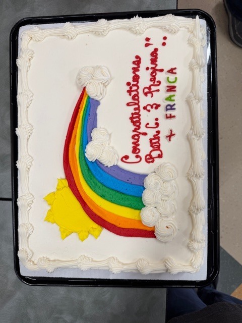 cake decorated with rainbow and words 