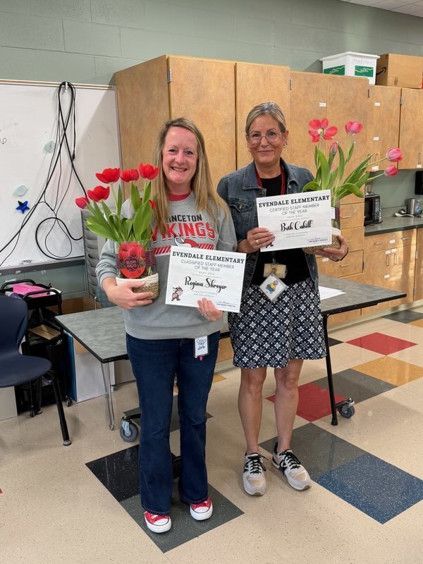 people holding flowers and awards 