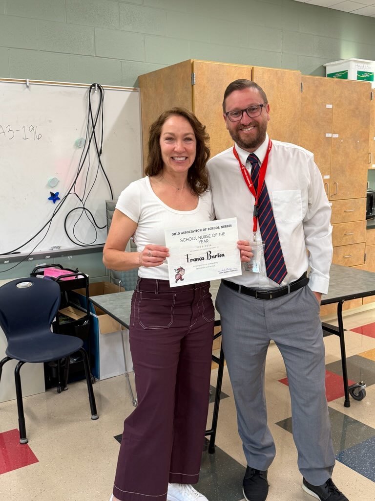 people holding flowers and awards 