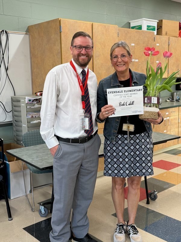 people holding flowers and awards 
