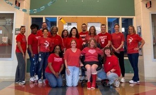 staff members dressed in red shirts 