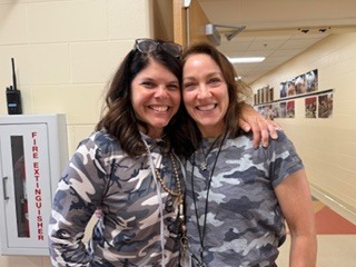 two adults dressed in camoflauge 