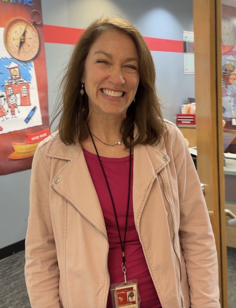 person smiling standing in a doorway