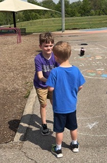 students and staff on the playground dancing
