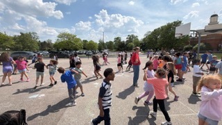 students and staff on the playground dancing