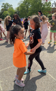 students and staff on the playground dancing