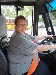person sitting in a bus seat 