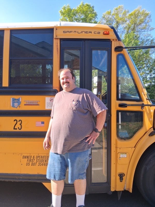 person standing in front of a bus 