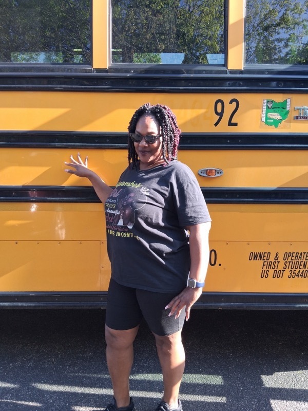 person standing in front of a bus 