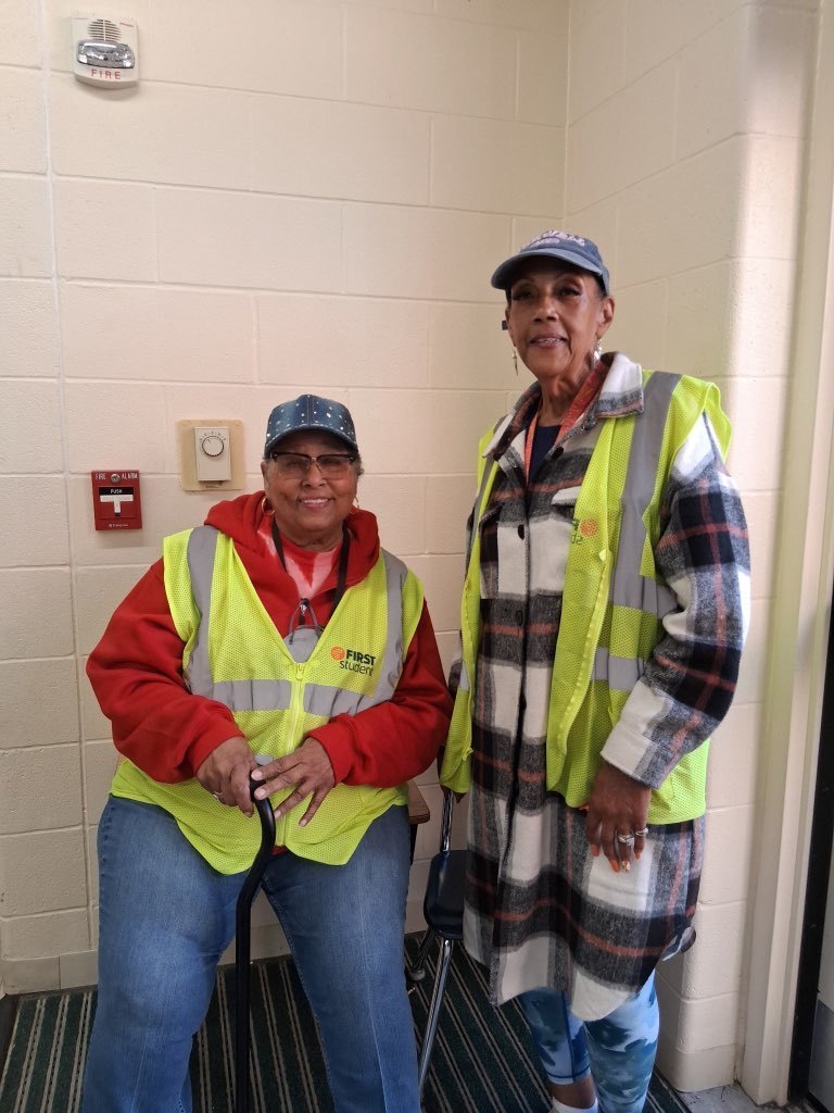 two people with yellow vests on 