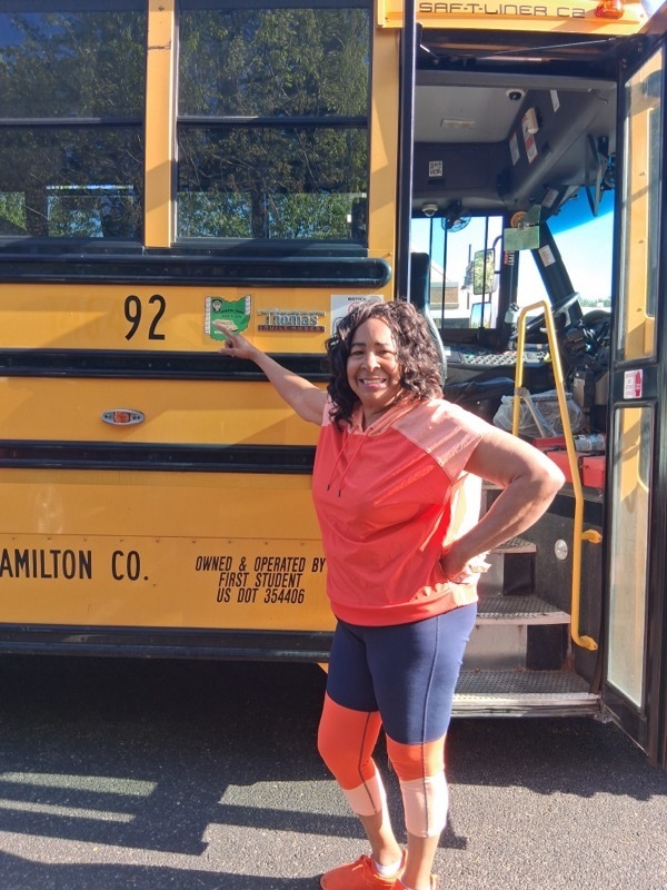 person standing in front of a bus 