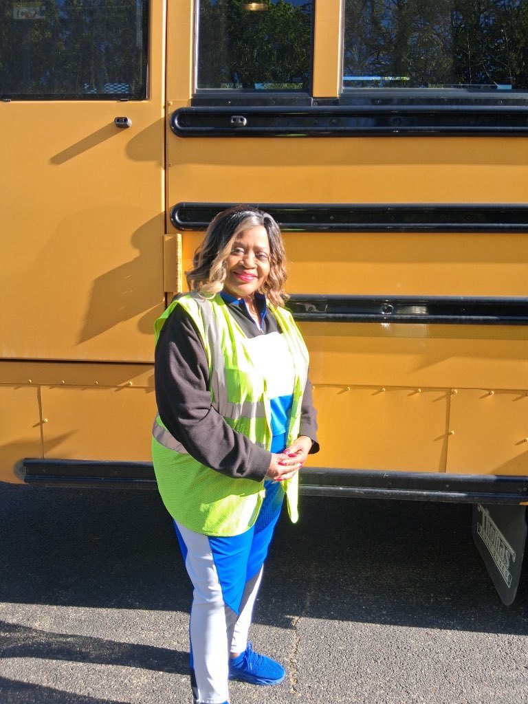 person standing in front of a bus 
