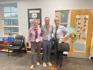 three people wearing ties and similar shirts