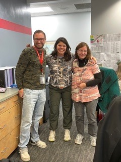 three people wearing camo in an office area