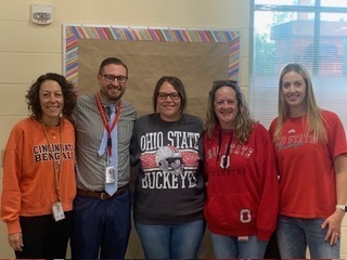 five people wearing sports shirts