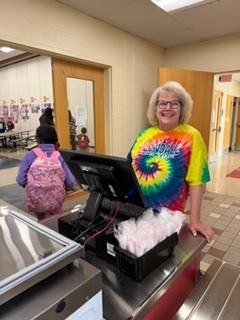 person wearing a colorful shirt standing in front of a computer