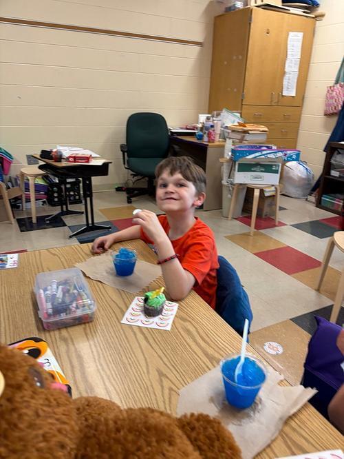 person with a table and sweet treats 