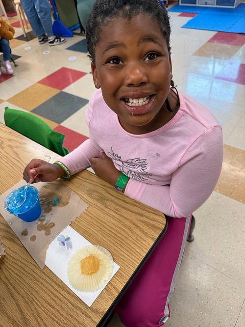 person with a table and sweet treats 