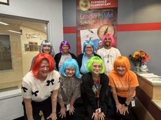 many people wearing colorful wigs 