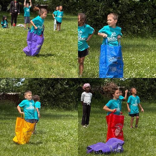people in matching shirts with grass around in sacks