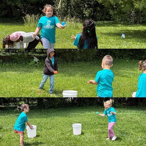 people in matching shirts with buckets of water