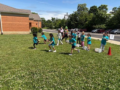 people with matching shirts running on the grass