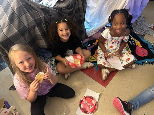 people in a classroom holding some smores 
