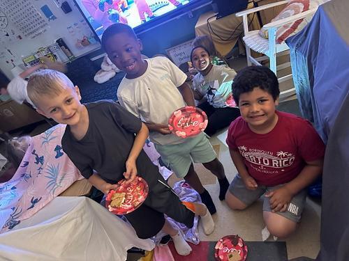 people in a classroom holding some smores 