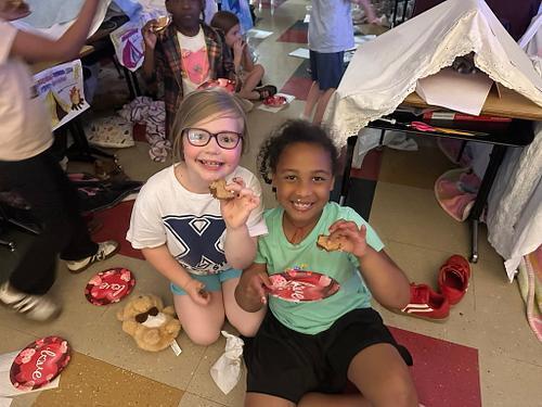 people in a classroom holding some smores 