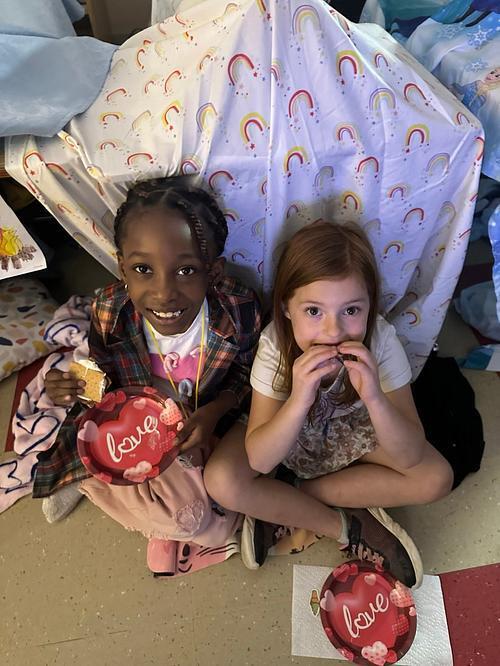 people in a classroom holding some smores 