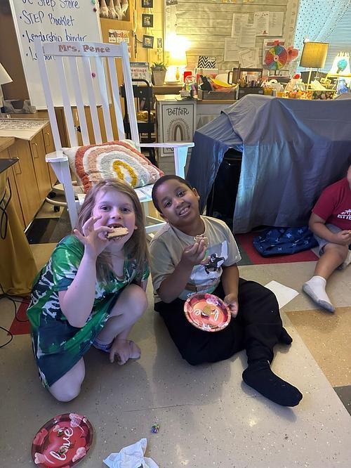 people in a classroom holding some smores 