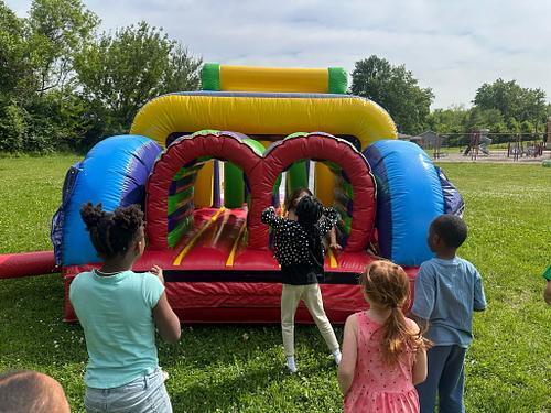 people in  a colorful bouncy house