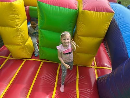 people in  a colorful bouncy house