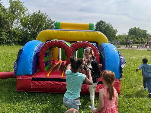 people in  a colorful bouncy house