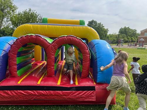 people in  a colorful bouncy house