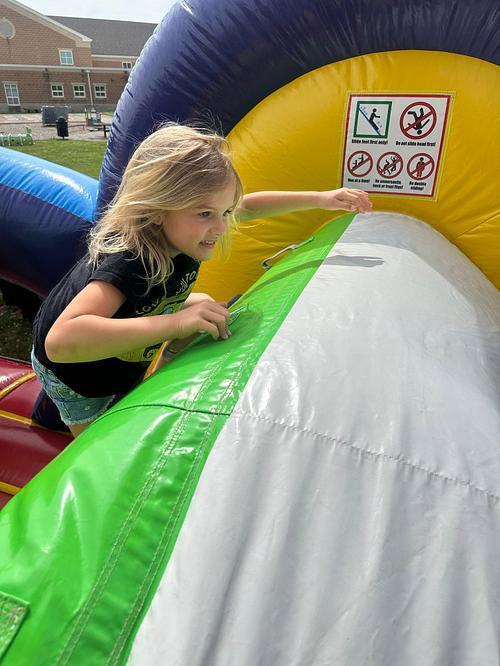 people in  a colorful bouncy house