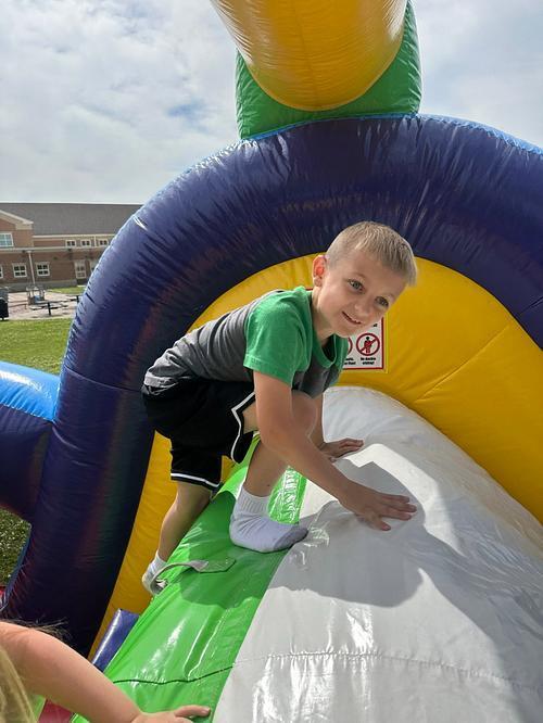 people in  a colorful bouncy house